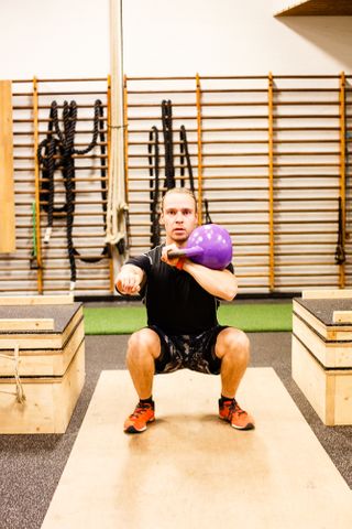 Squat with one arm kb in rack position